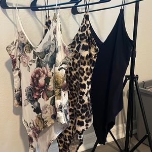 Three size small body suits